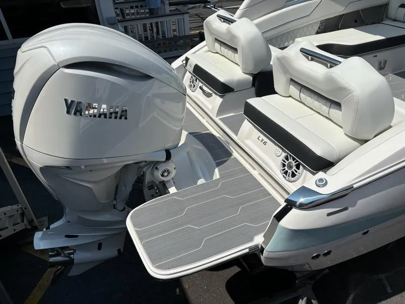 Slide: The Image of 2025 Regal LX6 boat with Yamaha outboard motor and luxurious seating. - 10