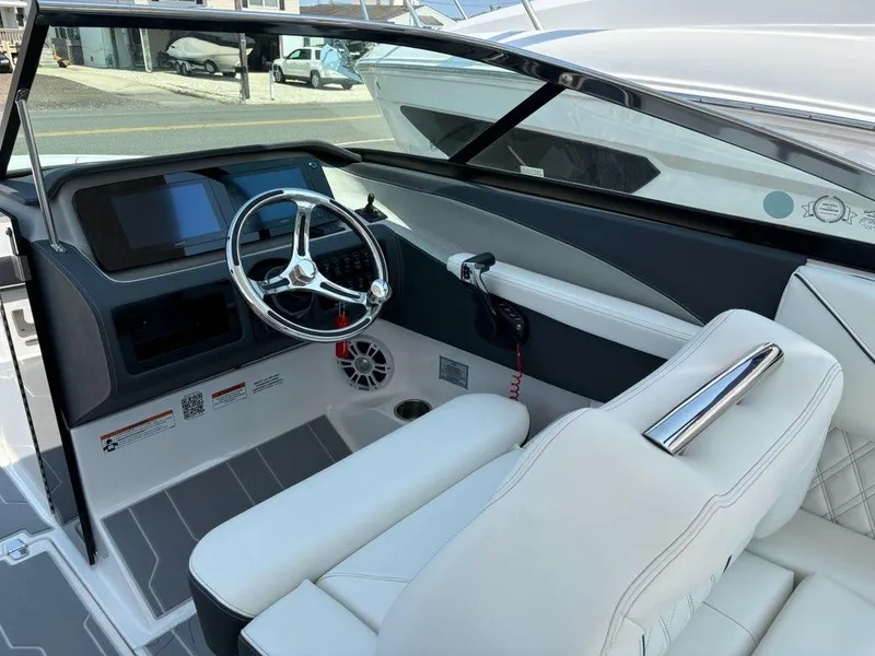 Slide: The Image of 2025 Regal LX6 boat interior with white leather seats and modern dashboard. - 3