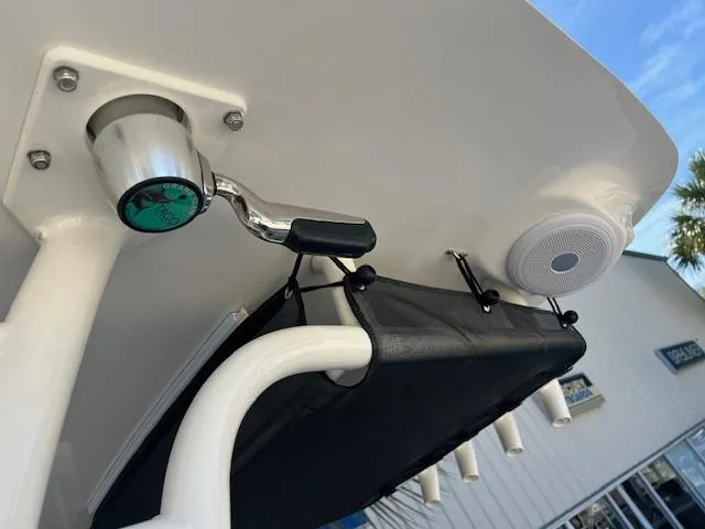 Slide: The Image of 2024 Key West 244 Center Console boat detail with rod holders and speaker. - 11