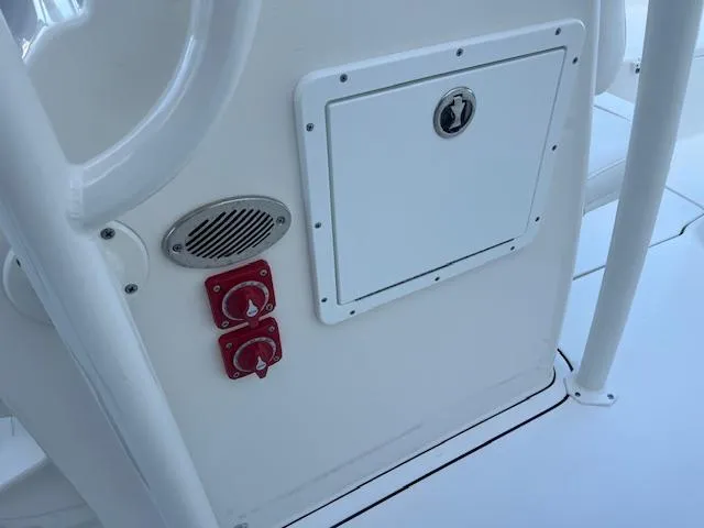 Slide: The Image of 2024 Key West 244 Center Console boat control panel with switches and storage compartment. - 15