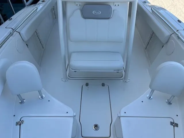 Slide: The Image of 2024 Key West 244 Center Console boat interior with white seating and storage compartments. - 18