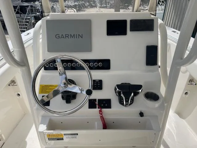 Slide: The Image of 2024 Key West 244 Center Console boat dashboard with Garmin navigation system. - 2