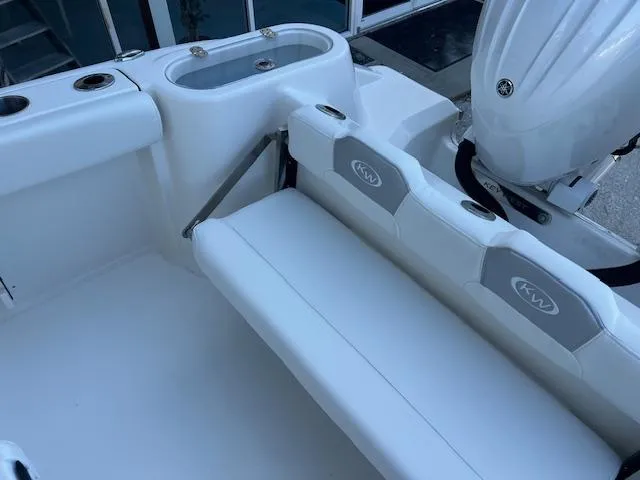 Slide: The Image of 2024 Key West 244 Center Console boat with white seating and motor. - 6