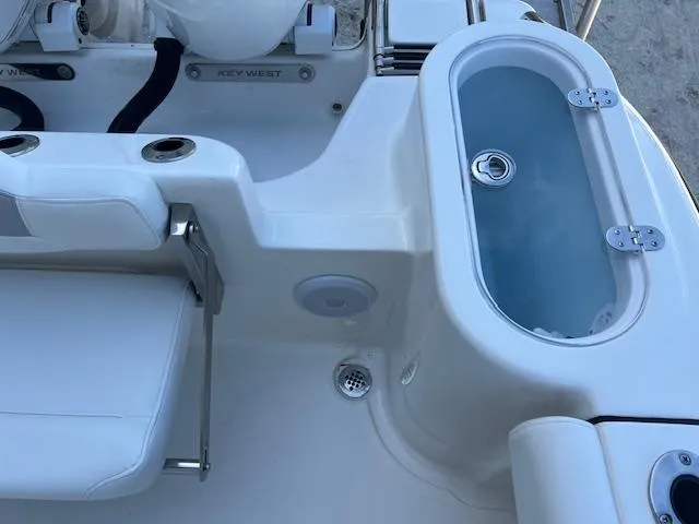 Slide: The Image of 2024 Key West 244 Center Console boat interior with seating and livewell. - 7