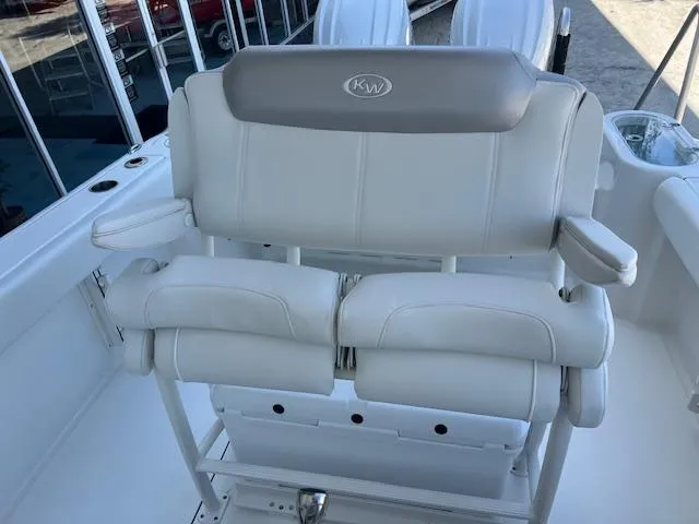 Slide: The Image of 2024 Key West 244 Center Console boat seating with cushioned backrest and armrests. - 9