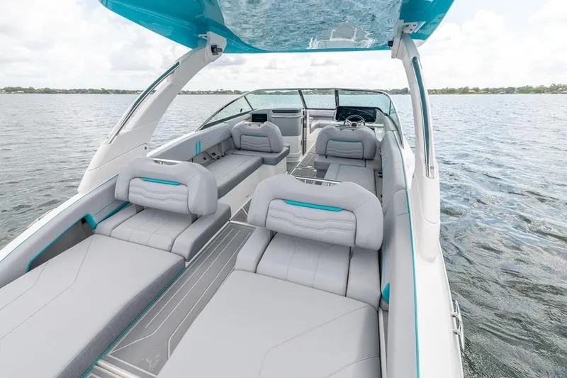 Slide: The Image of 2024 Regal LX9 boat interior with luxurious seating on a serene lake. - 14