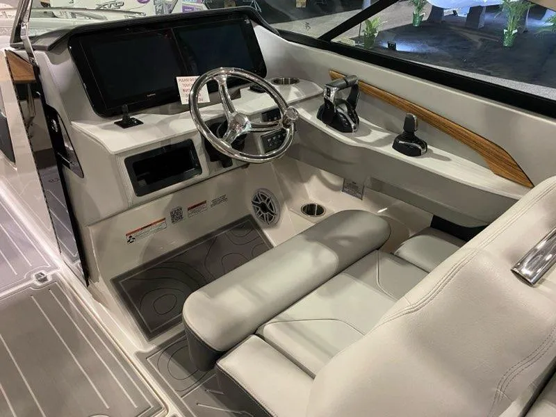Slide: The Image of 2024 Regal LX9 boat cockpit with modern steering, dual screens, and sleek interior design. - 6