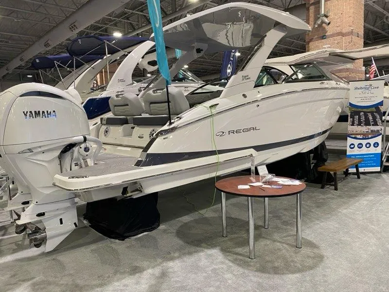 Slide: The Image of 2024 Regal LX9 boat displayed indoors with Yamaha engine, showcasing sleek design and modern features. - 7