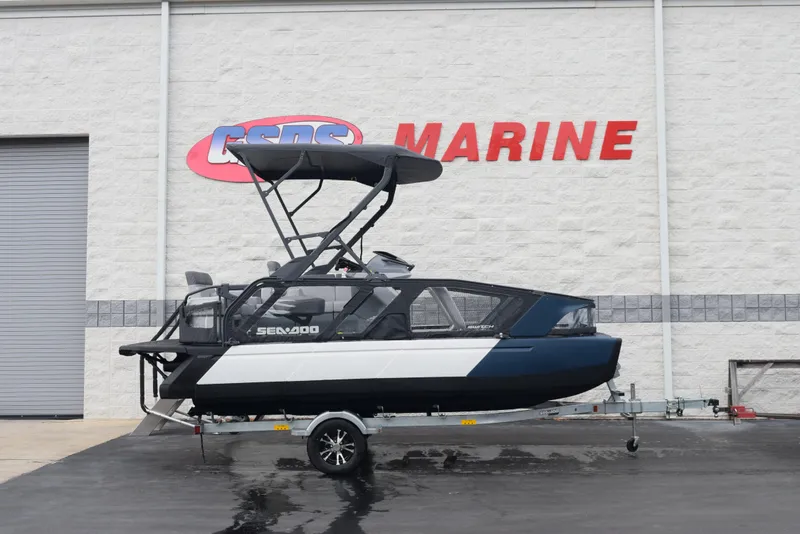 The Image of 2024 Sea-Doo Switch Sport 18 boat on trailer outside dealership. - 1