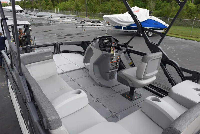 Slide: The Image of 2024 Sea-Doo Switch Sport 18 pontoon boat interior with seating and control console. - 11