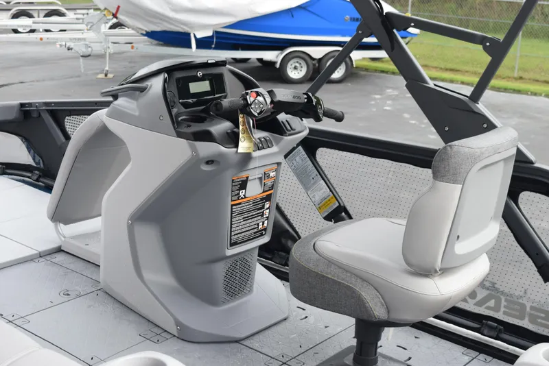 Slide: The Image of 2024 Sea-Doo Switch Sport 18 cockpit with steering console and captain's chair. - 13