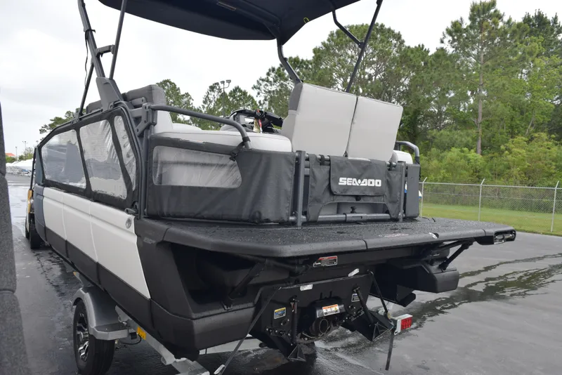 Slide: The Image of 2024 Sea-Doo Switch Sport 18 pontoon boat on a trailer, rear view. - 6