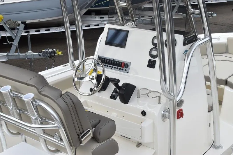 Slide: The Image of 2024 Key West 219 FS boat console with steering wheel, controls, and seating. - 10