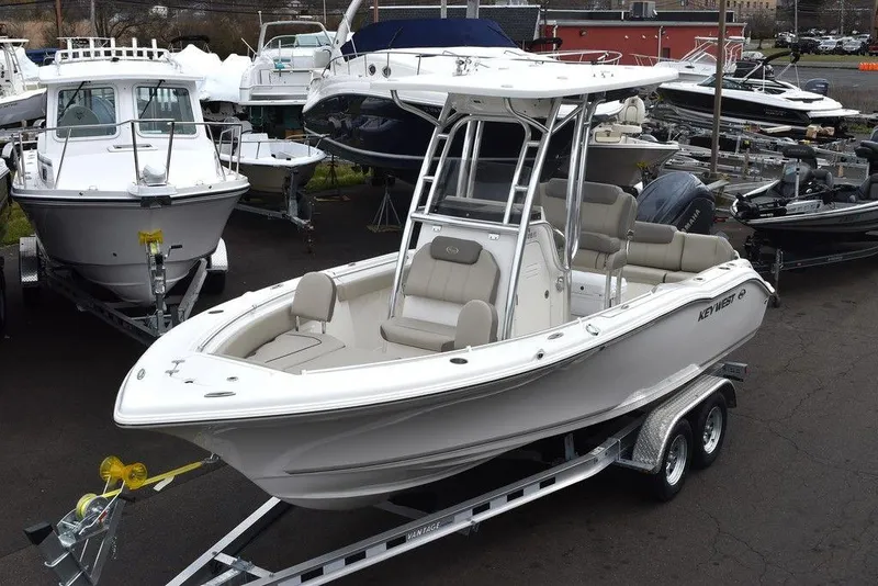 Slide: The Image of 2024 Key West 219 FS boat on trailer in marina. - 2
