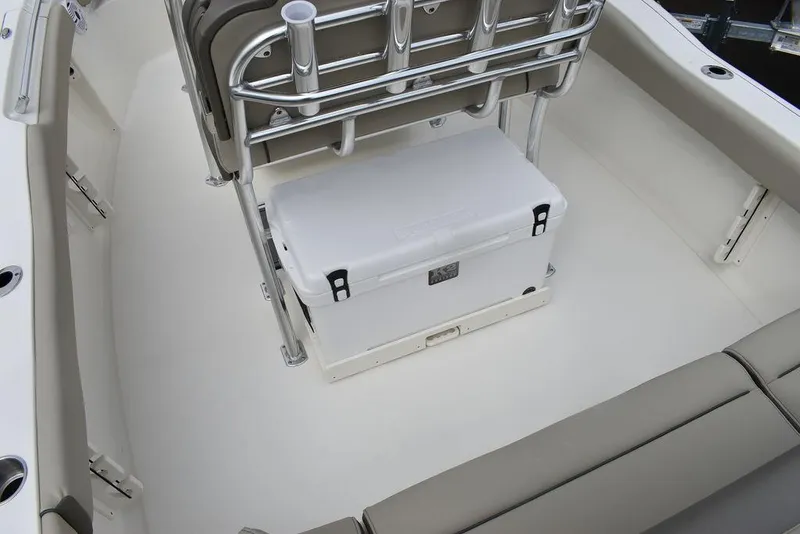 Slide: The Image of 2024 Key West 219 FS boat interior with cooler and seating. - 23