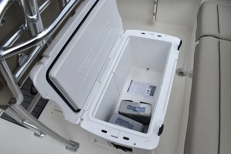 Slide: The Image of Open storage compartment on 2024 Key West 219 FS boat with HoseCoil box inside. - 25