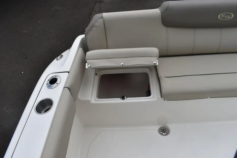Slide: The Image of 2024 Key West 219 FS boat with open storage compartment and cup holders. - 29