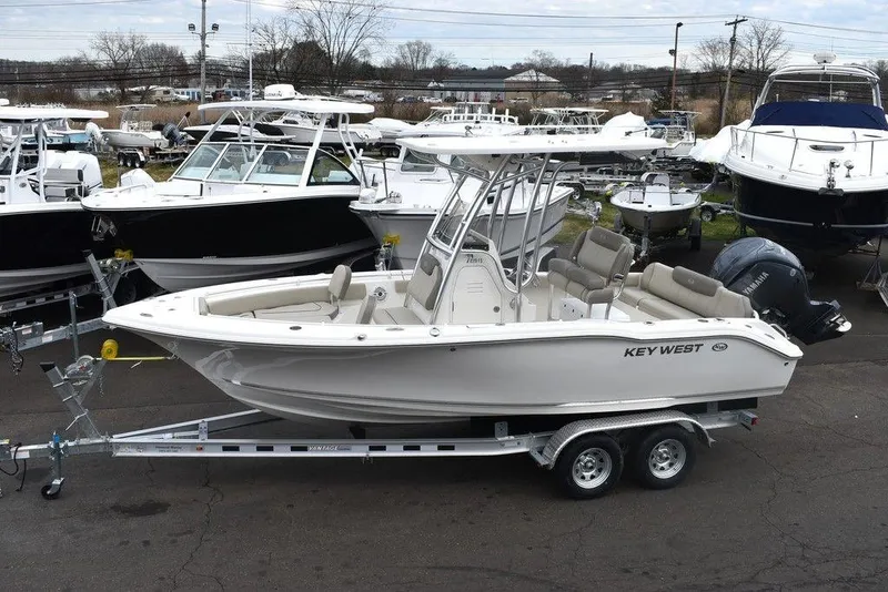 Slide: The Image of 2024 Key West 219 FS boat on trailer in marina. - 3