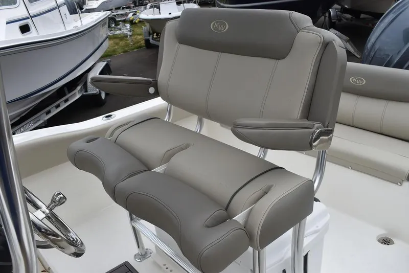 Slide: The Image of 2024 Key West 219 FS boat with cushioned seating and steering wheel. - 36