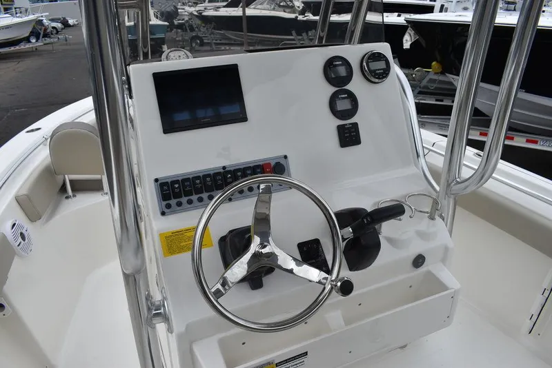 Slide: The Image of 2024 Key West 219 FS boat console with steering wheel and control panel. - 37