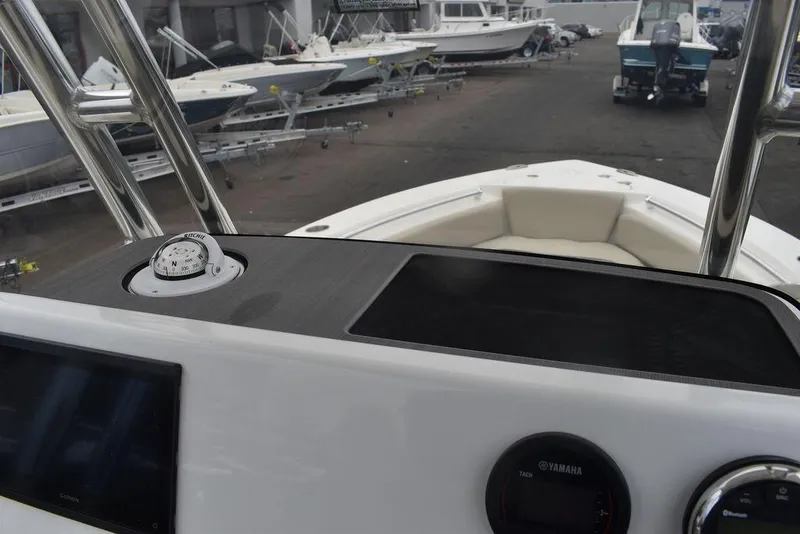 Slide: The Image of 2024 Key West 219 FS boat dashboard and bow area in a marina. - 40
