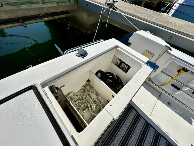 Slide: The Image of Open storage compartment on 2004 Albin 35 Command Bridge boat, showing ropes and equipment. - 10
