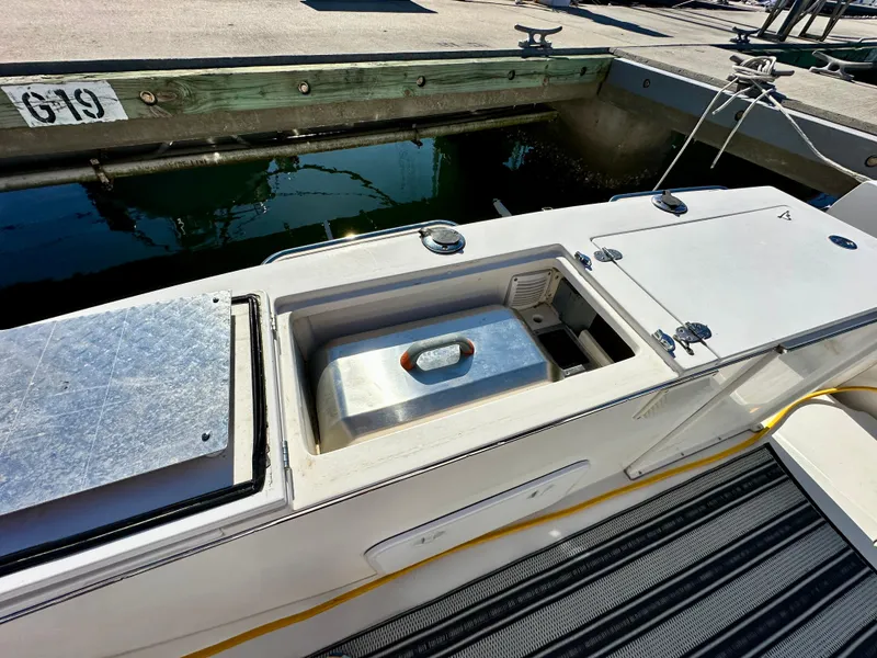 Slide: The Image of 2004 Albin 35 Command Bridge boat with open storage compartment at dock. - 11