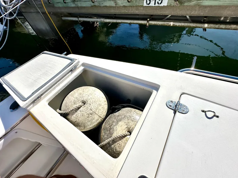 Slide: The Image of Open storage compartment on 2004 Albin 35 Command Bridge boat with fenders inside. - 13