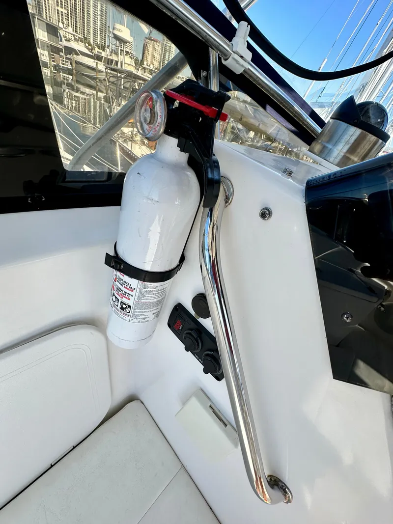 Slide: The Image of Fire extinguisher on 2004 Albin 35 Command Bridge boat, near control panel and railing. - 14