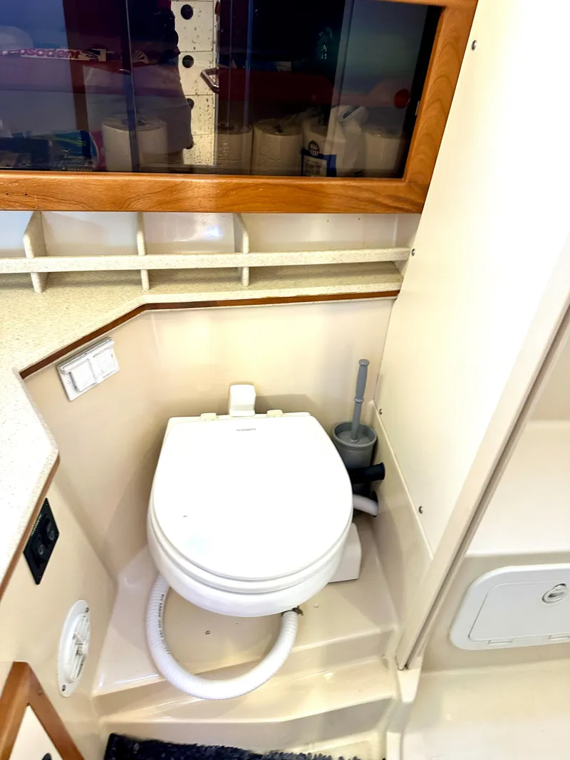 Slide: The Image of 2004 Albin 35 Command Bridge bathroom with toilet and storage shelves. - 26