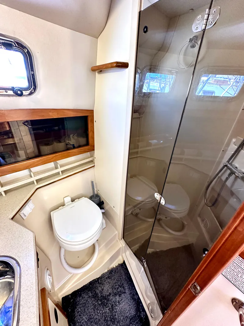 Slide: The Image of 2004 Albin 35 Command Bridge bathroom with shower, toilet, and window. - 28