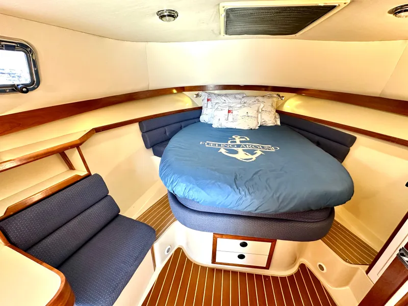 Slide: The Image of 2004 Albin 35 Command Bridge cabin with cozy bed and wooden accents. - 29