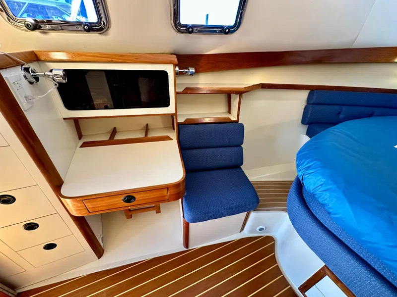 Slide: The Image of 2004 Albin 35 Command Bridge interior with wooden accents and blue seating. - 30