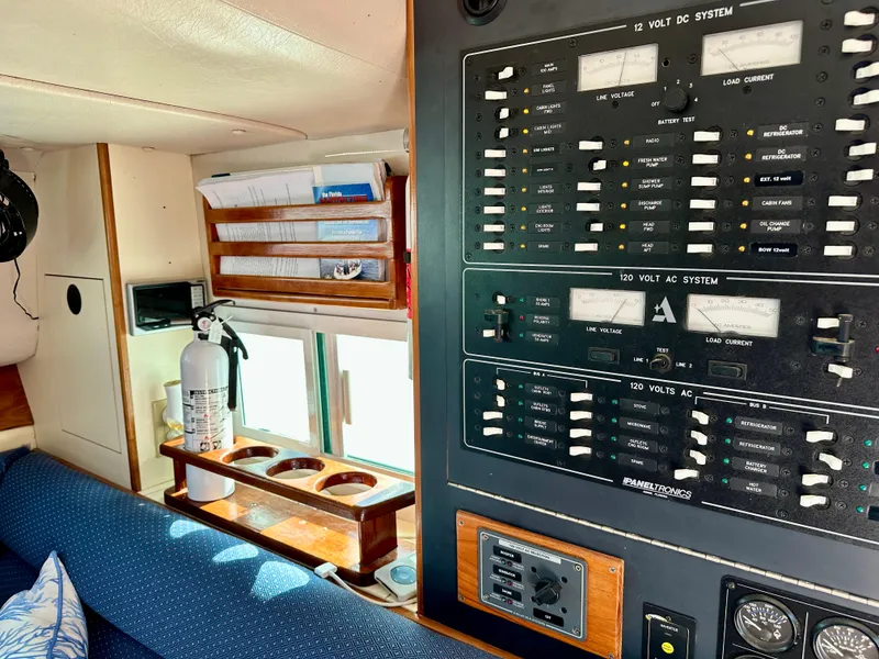 Slide: The Image of 2004 Albin 35 Command Bridge interior with control panel and fire extinguisher. - 35