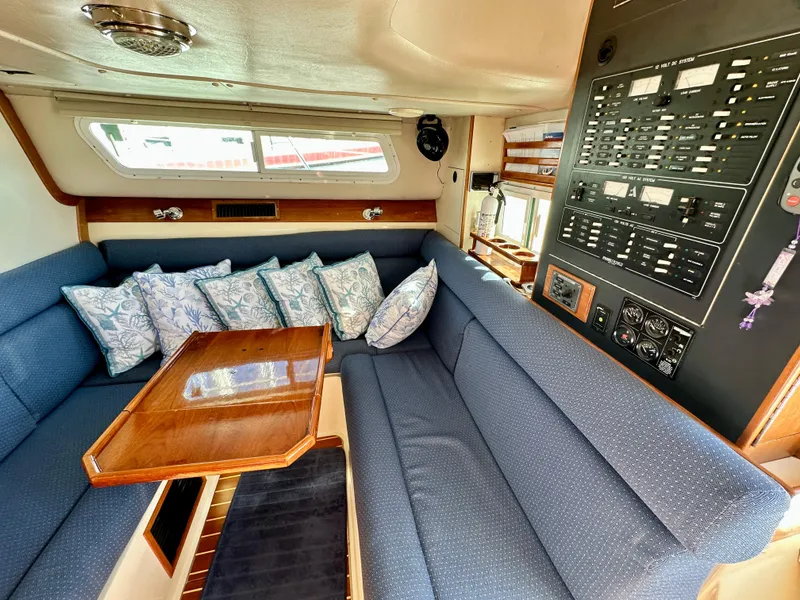 Slide: The Image of Interior of 2004 Albin 35 Command Bridge with blue seating and control panel. - 39