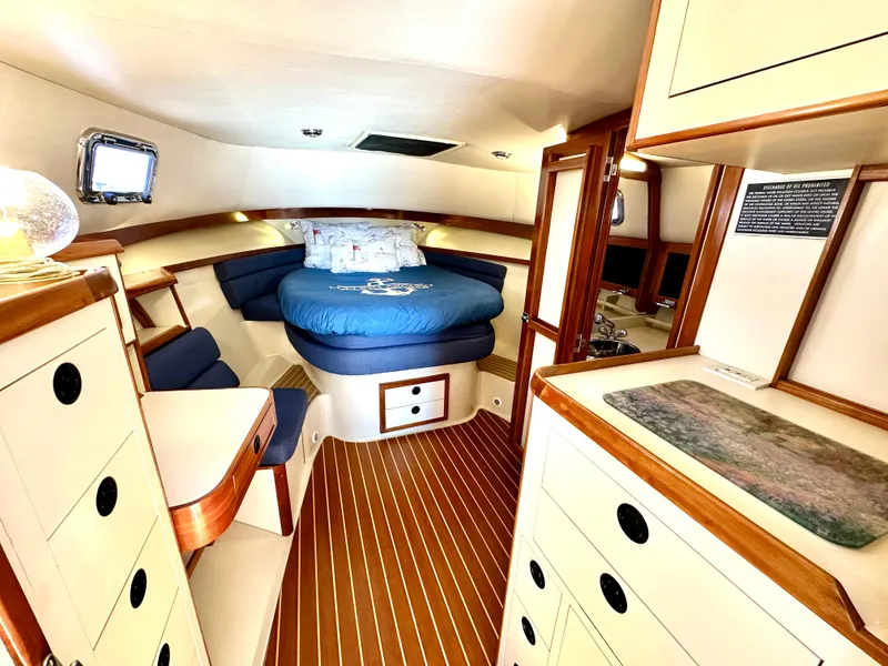 Slide: The Image of Interior of 2004 Albin 35 Command Bridge with cozy bed and wooden cabinetry. - 40