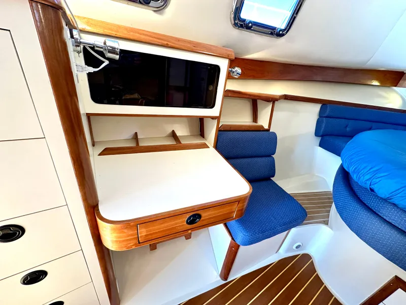 Slide: The Image of Interior of 2004 Albin 35 Command Bridge with wood accents and blue seating. - 41