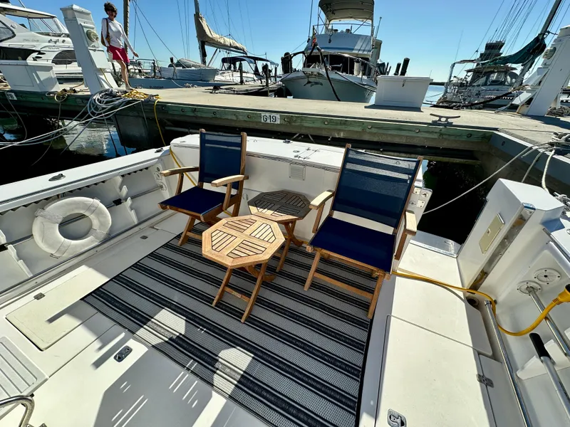 Slide: The Image of 2004 Albin 35 Command Bridge yacht deck with chairs and table at marina. - 42