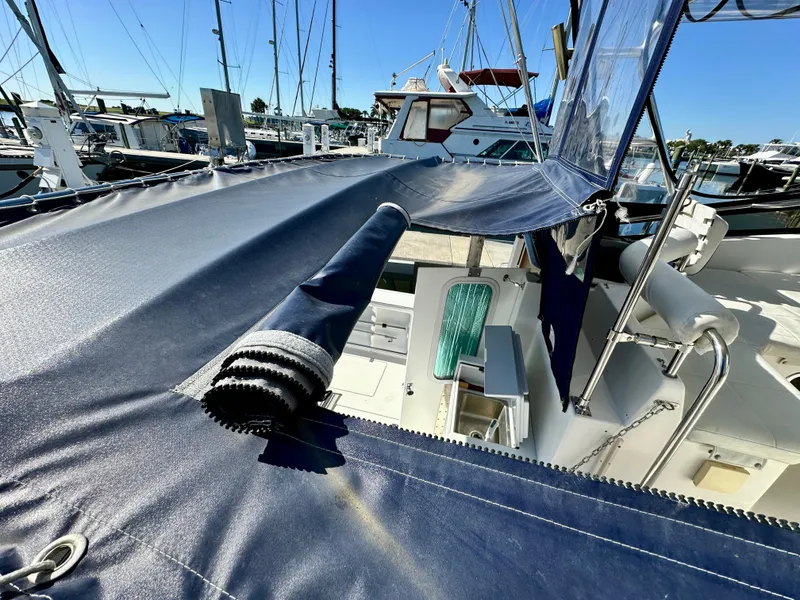 Slide: The Image of 2004 Albin 35 Command Bridge yacht with blue canvas cover in marina. - 45