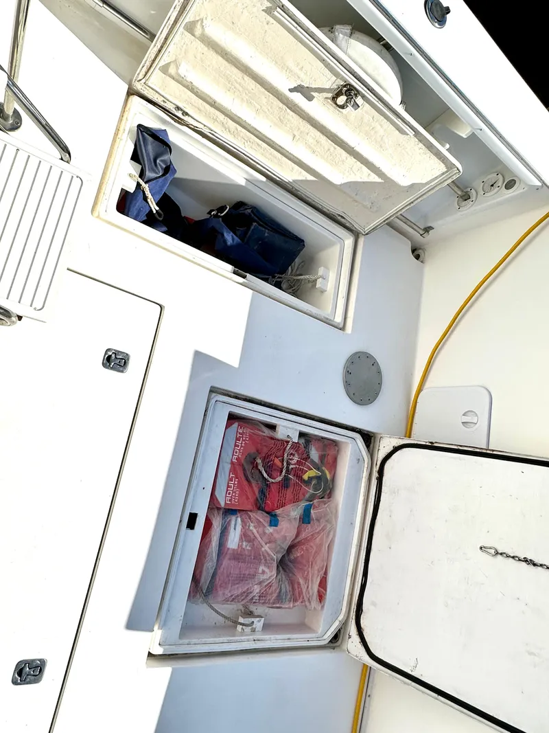 Slide: The Image of Open storage compartments on a 2004 Albin 35 Command Bridge boat deck. - 49