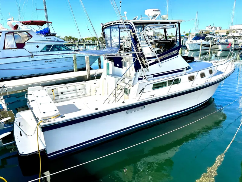 Slide: The Image of 2004 Albin 35 Command Bridge yacht docked in a marina under clear blue skies. - 6