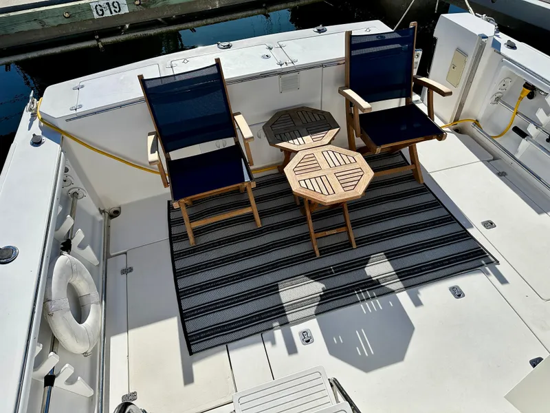Slide: The Image of Deck of 2004 Albin 35 Command Bridge with chairs and tables. - 7