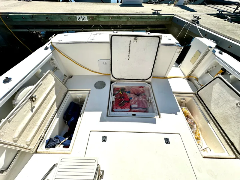 Slide: The Image of 2004 Albin 35 Command Bridge boat deck with open storage compartments at dock. - 8