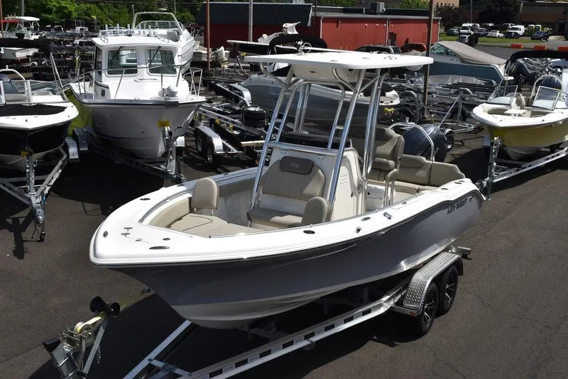 Slide: The Image of 2024 Key West 219 FS boat on trailer in a marina. - 1