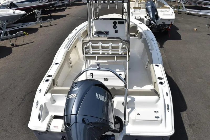 Slide: The Image of 2024 Key West 219 FS boat with Yamaha 200 engine, docked in a marina. - 11