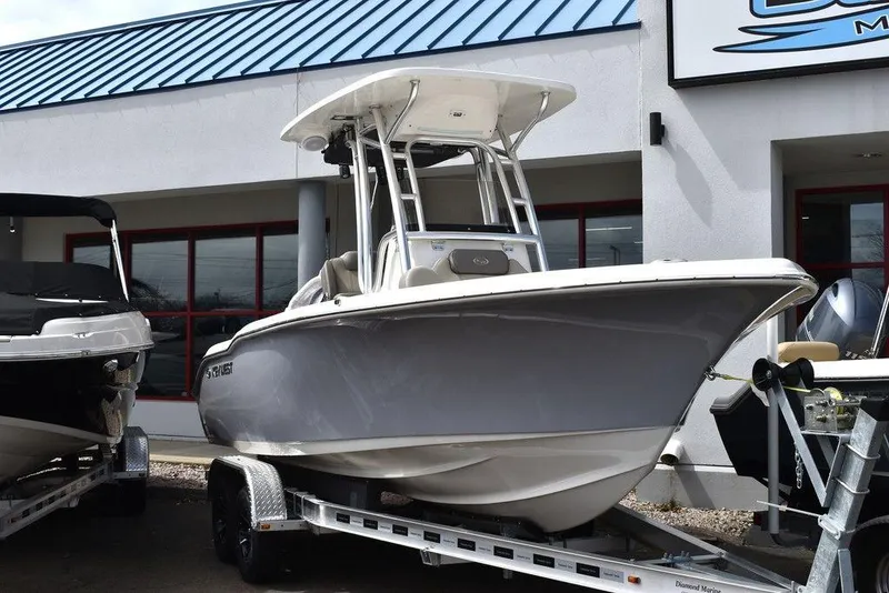Slide: The Image of 2024 Key West 219 FS boat on a trailer outside a dealership. - 2