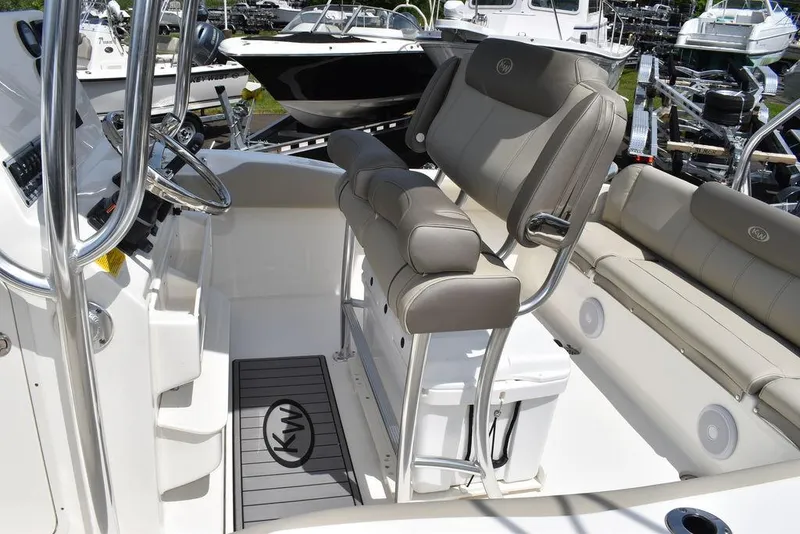 Slide: The Image of 2024 Key West 219 FS boat interior with cushioned seating and console. - 24