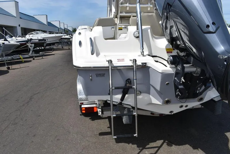 Slide: The Image of 2024 Key West 219 FS boat rear view with ladder and outboard motor. - 27