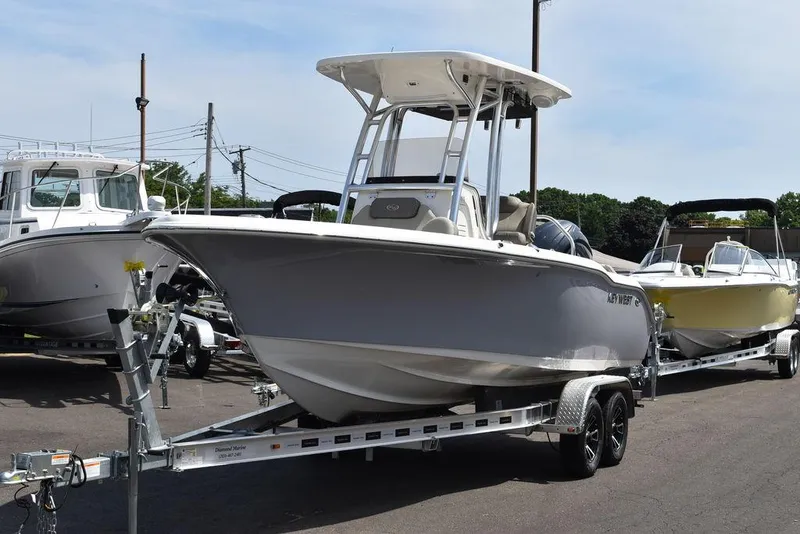 Slide: The Image of 2024 Key West 219 FS boat on a trailer in a marina. - 3