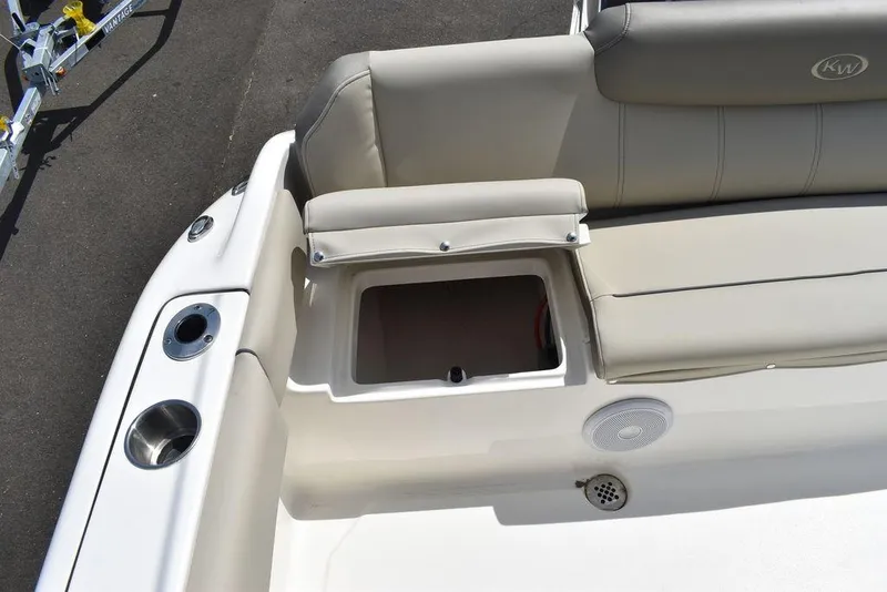Slide: The Image of 2024 Key West 219 FS boat with open storage compartment and cushioned seating. - 31